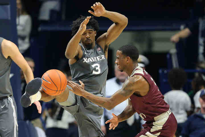 Xavier guard Quentin Goodin (3) deflects a pass with his leg by Eastern Kentucky's JacQuess Hobbs (1) in the second half of a game at Cintas Center in Cincinnati.